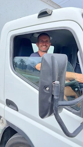 Andy smiling from the driver's seat of the North Star truck