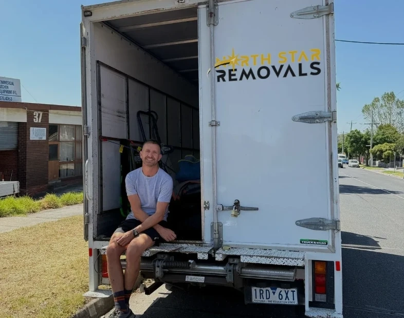 Andy sitting on the back of the North Star Removals truck